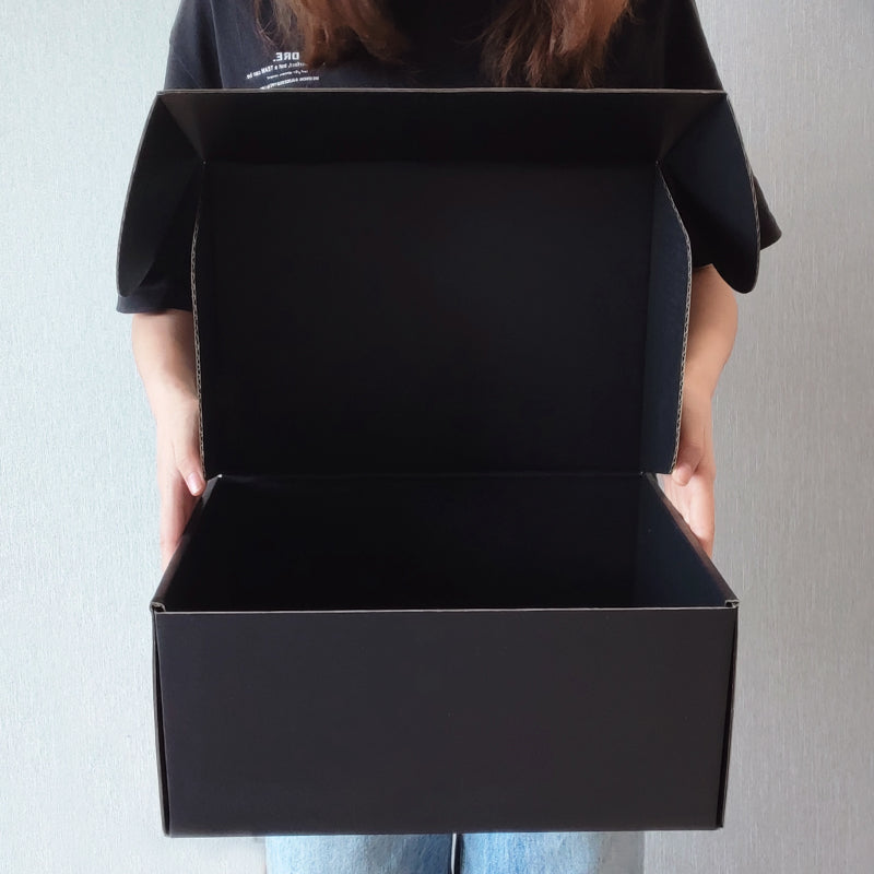 Black Kraft cardboard gift box with glossy lamination, eco-friendly packaging, for food, perfume, watches, jewelry, made from recycled corrugated paper. 