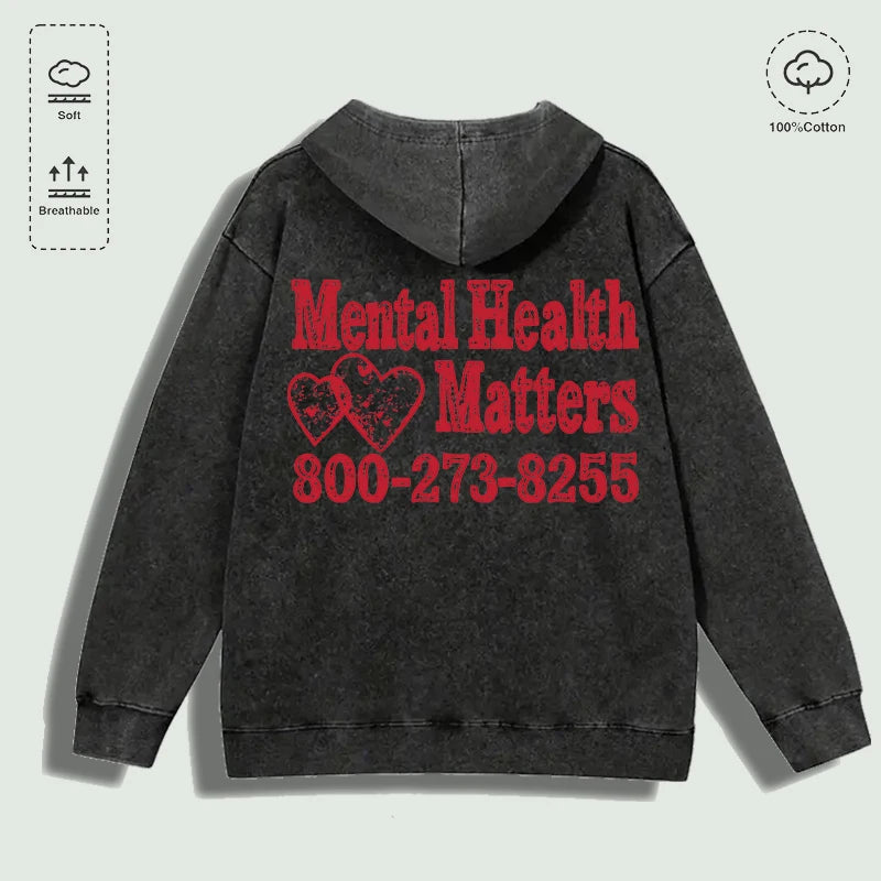 Áo hoodie đen mặt sau, chữ đỏ "Mental Health Matters" và số điện thoại, chất liệu 100% cotton.