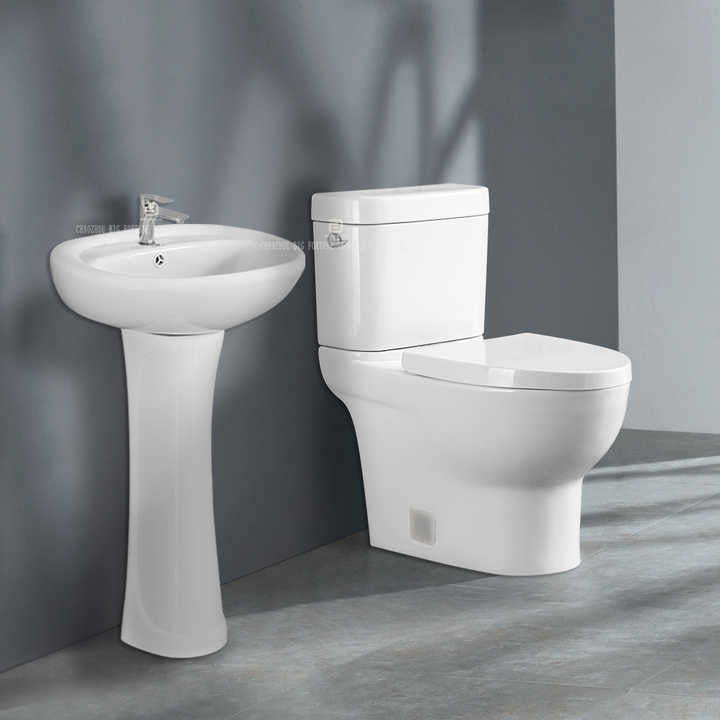 Hotel bathroom, toiletries cabinet, two-piece toilet and cheap porcelain wash basin 