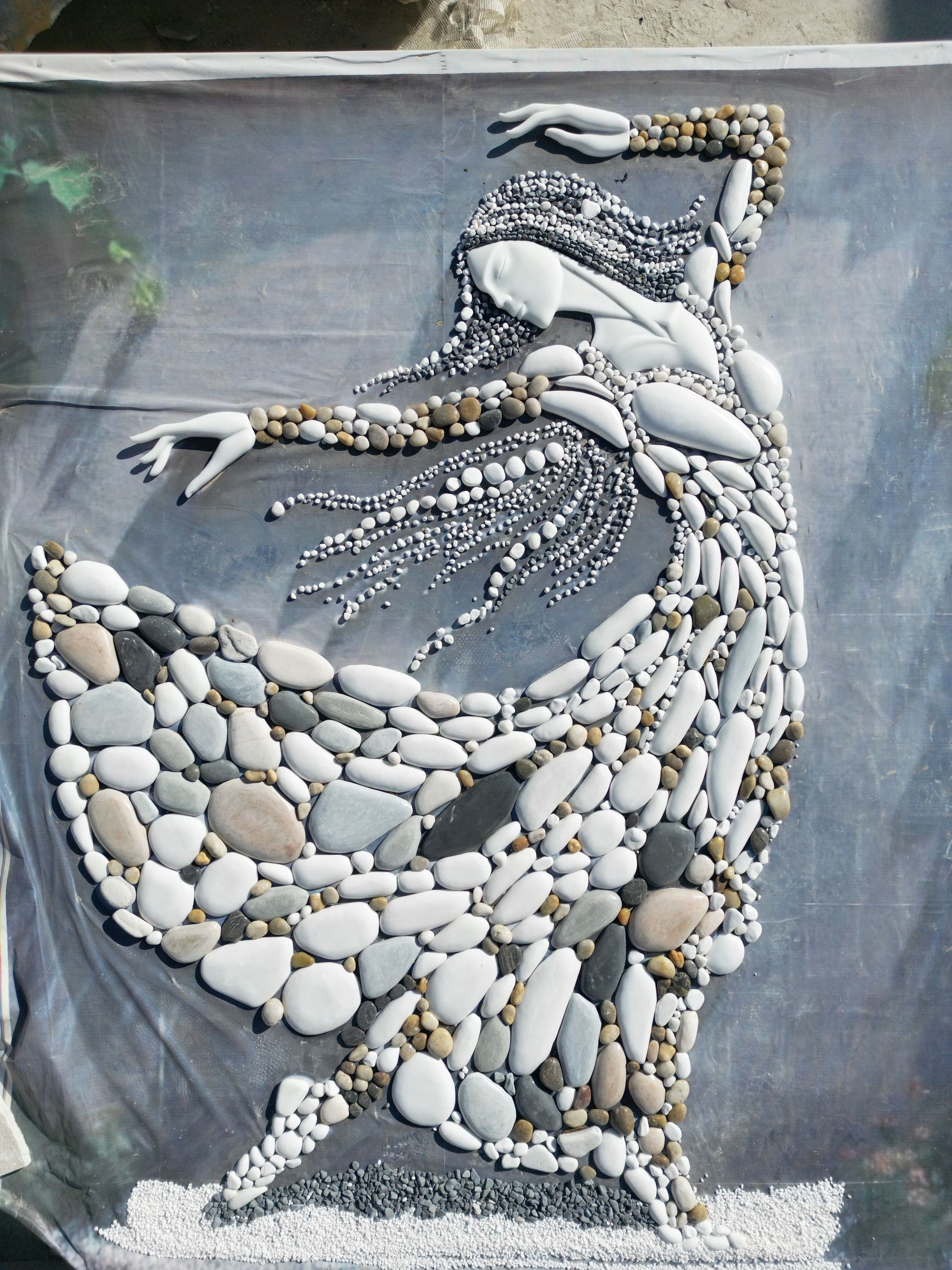 Multi-colored natural stone mosaic painting of women wearing clothes 