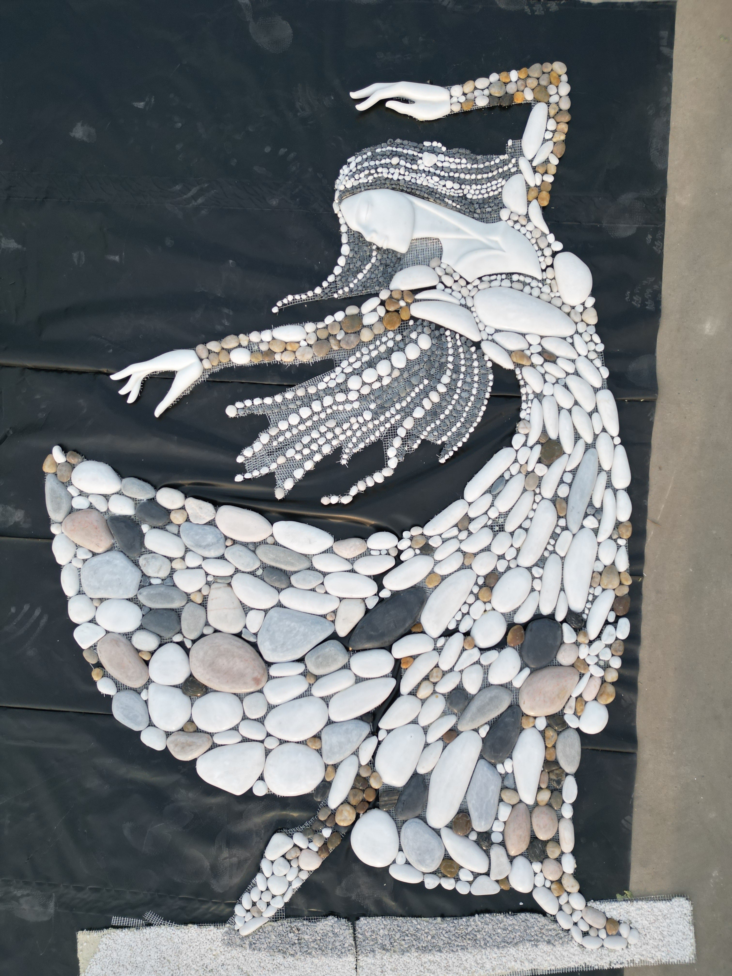 Multi-colored natural stone mosaic painting of women wearing clothes 