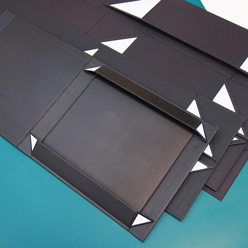 Black Kraft cardboard gift box with glossy lamination, eco-friendly packaging, for food, perfume, watches, jewelry, made from recycled corrugated paper. 