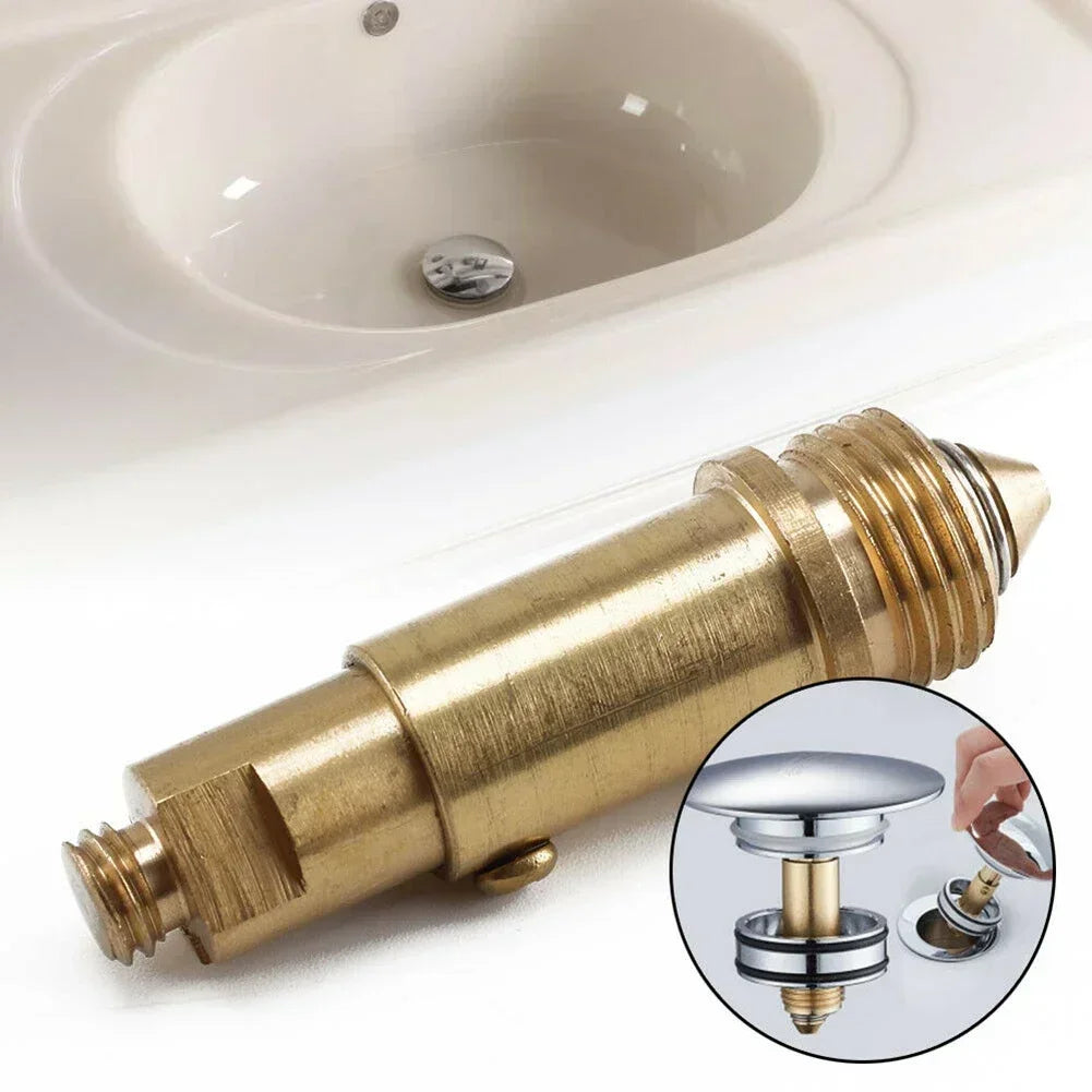 Ống thoát nước bằng đồng thau, lắp đặt trong bồn rửa màu trắng; hình tròn nhỏ minh họa chi tiết.