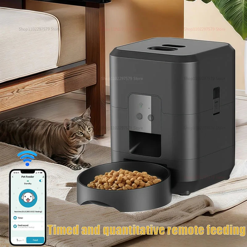 Máy cho thú cưng màu đen với khay thức ăn và một con mèo nằm cạnh giường.