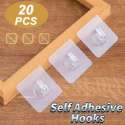 Ba móc dán nhựa trong suốt trên khung gỗ, chữ "20 PCS" và "Self Adhesive Hooks".