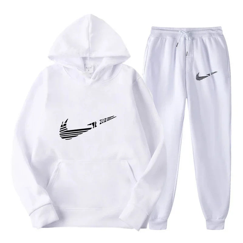 Bộ đồ thể thao trắng gồm áo hoodie và quần, in logo đen cách điệu.