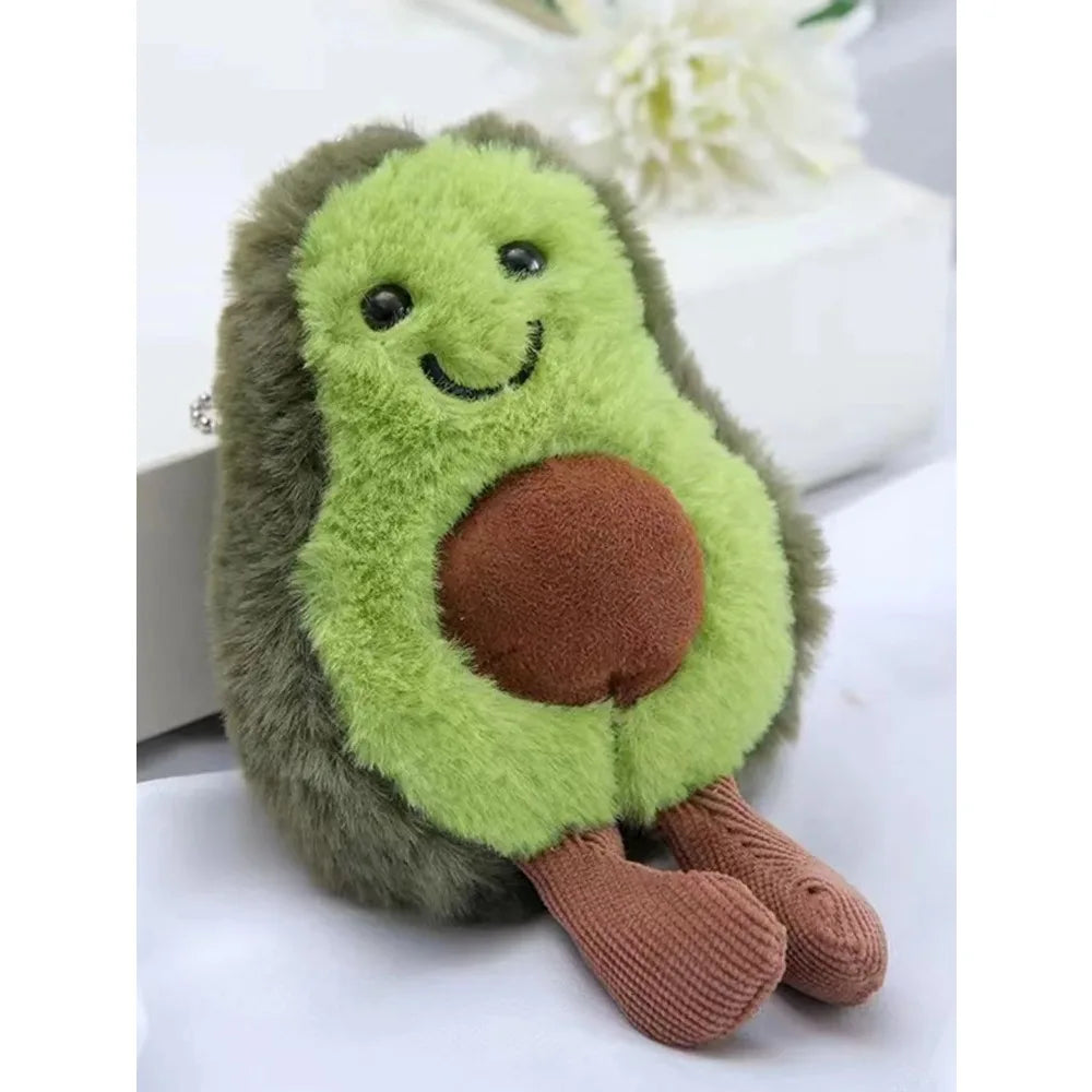 Gấu bông hình quả bơ màu xanh lá, nâu, có mặt cười và đôi chân dài màu nâu nhạt.