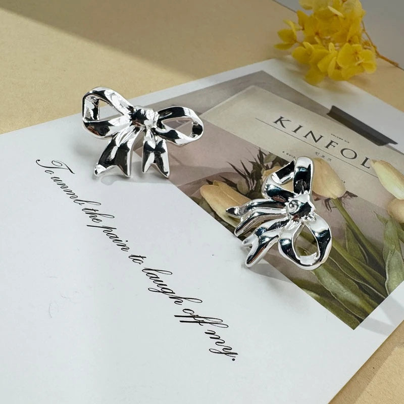 Shiny Silver Bow: Elegant Earrings For Women