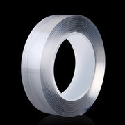 Cuộn băng keo trong suốt trên nền đen, nổi bật với ánh sáng phản chiếu.
