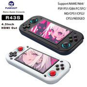 Hai máy chơi game cầm tay, một đen, một trắng, màn hình hiển thị hình ảnh anime.