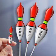 Bốn phao câu cá màu đỏ, trắng, có chữ đen, kích thước khác nhau. Một phao cầm trên tay.
