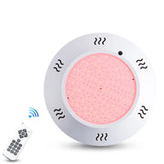 Đèn tròn LED hồng với điều khiển từ xa màu trắng.