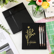 Hộp quà đen có hoa vàng và chữ "Awesome", kèm ba bút bên cạnh lọ hoa tulip.