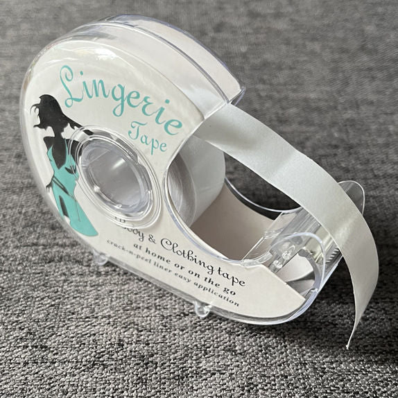 Cuộn băng dính trong suốt trên nền xám, nhãn có hình người và chữ "Lingerie Tape".