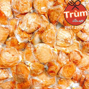 Nhiều viên chả cá chiên vàng ươm bọc trong túi nhựa, logo "Trùm Ăn Vặt" góc phải.