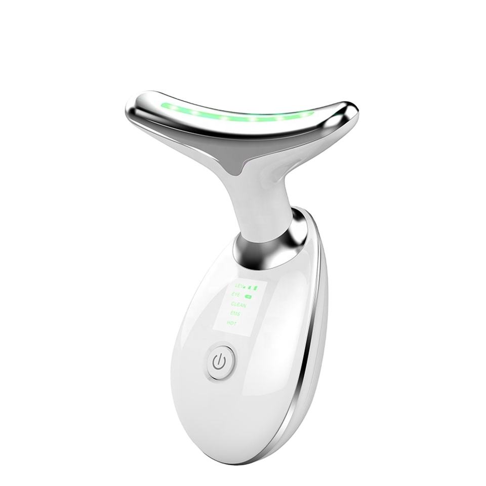 Thiết bị mát xa mặt màu trắng, có đèn LED xanh, hình chữ T, nút nguồn phía trước.