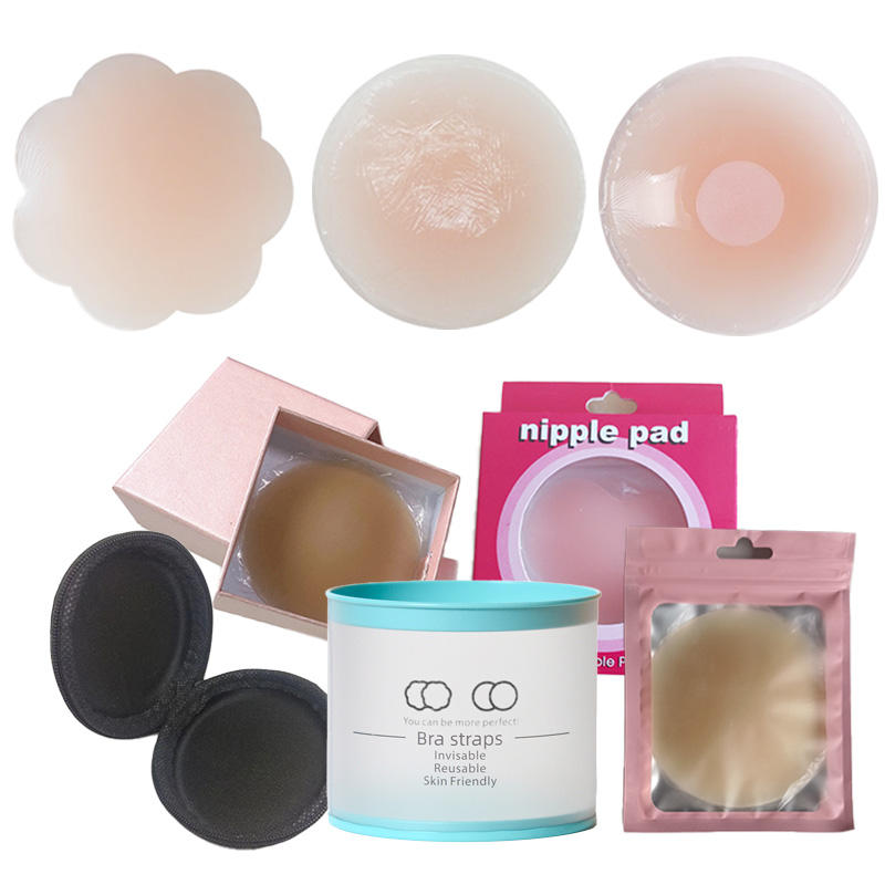 Các miếng dán ngực nhiều hình dáng, màu nude, với hộp đựng màu hồng và xanh ngọc.