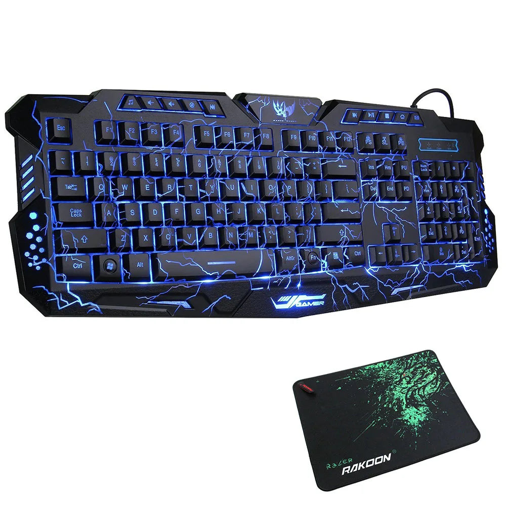 Bàn phím game màu đen với đèn LED xanh sáng, kèm lót chuột đen họa tiết xanh.