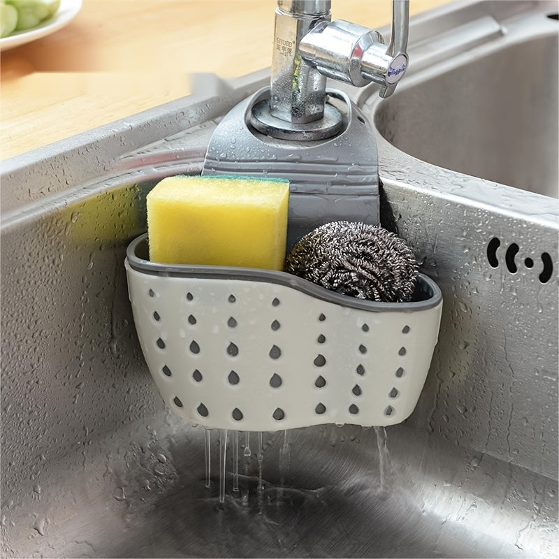 Giá treo bồn rửa màu trắng chứa miếng bọt biển vàng và búi cọ kim loại.