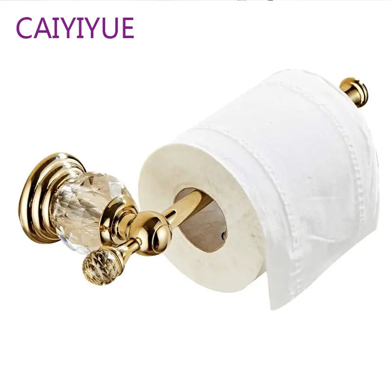 Giá đỡ giấy vệ sinh mạ vàng với chi tiết pha lê và cuộn giấy trắng.