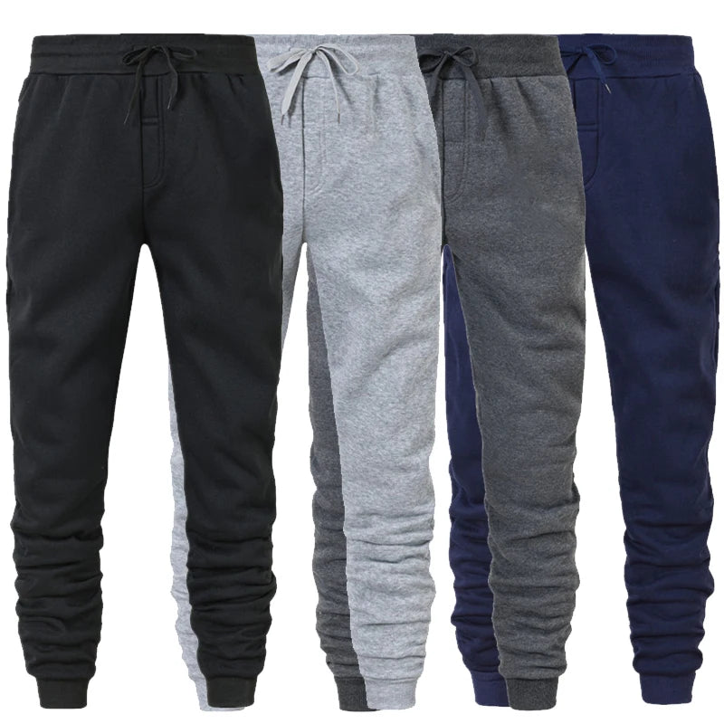 Bốn chiếc quần jogger màu đen, xám nhạt, xám đậm và xanh đen với dây thắt lưng.