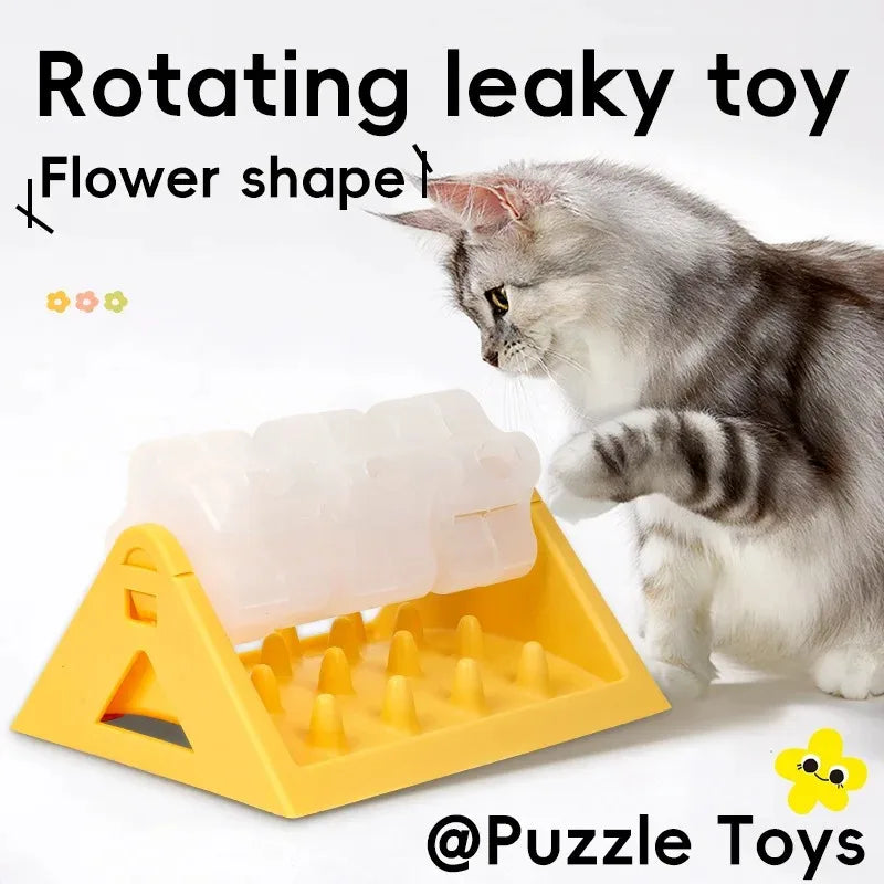 Mèo nhìn đồ chơi xoay màu vàng hình hoa, nền trắng, chữ "@Puzzle Toys".