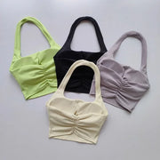 Bốn áo crop top, màu xanh lá, đen, tím nhạt, và kem trên nền trắng.